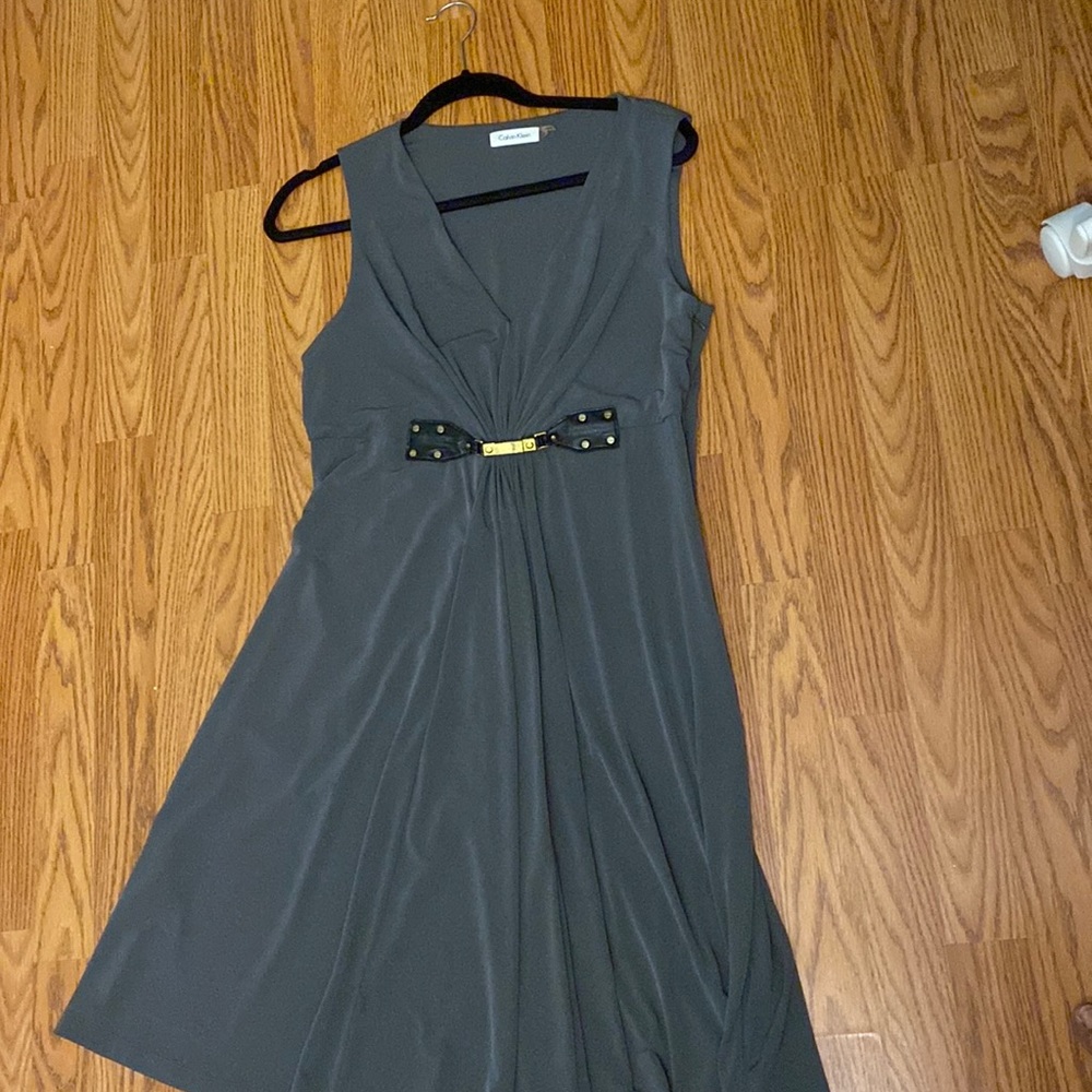 Calvin Klien side sipping green dress